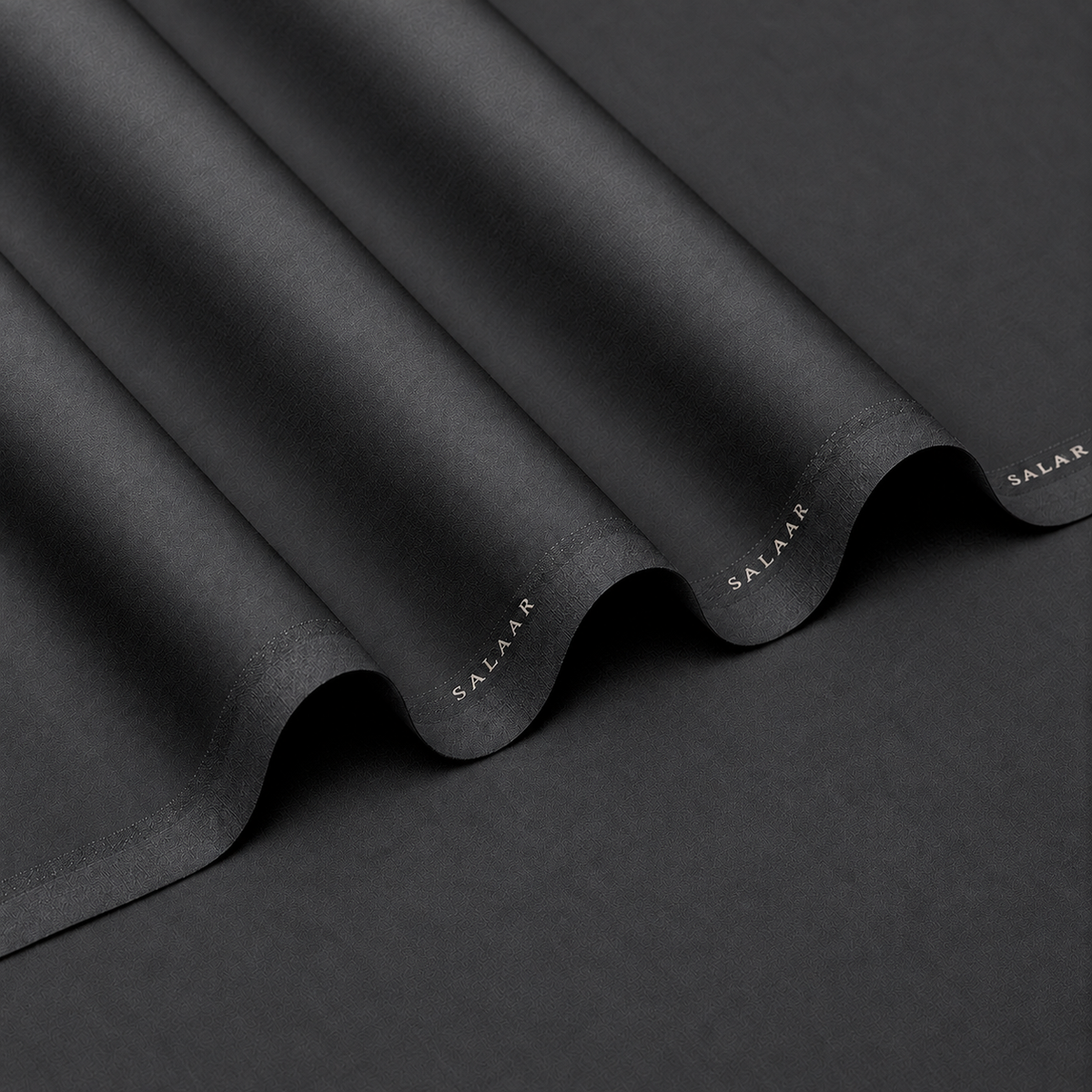 SALAAR Ashford Charcoal Summer Blend fabric with flowing folds and SALAAR woven border
