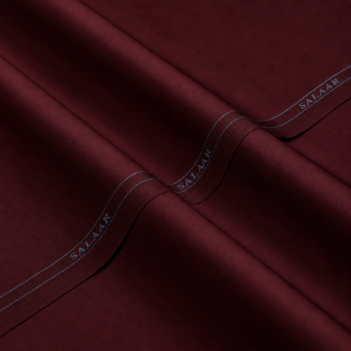 SALAAR Burgundy Crest Signature Blend fabric with woven SALAAR selvedge border