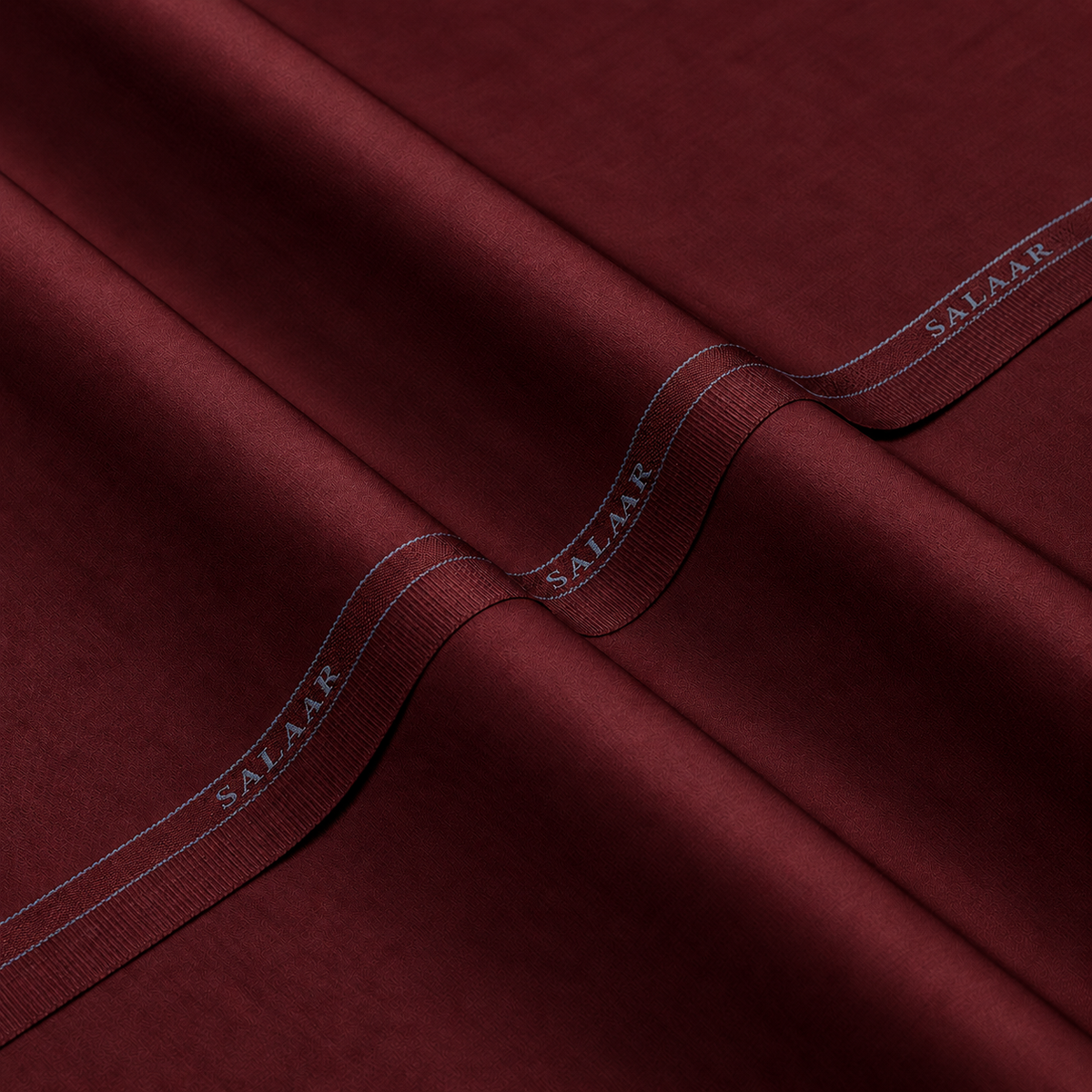 SALAAR Burgundy Royale Summer Blend fabric with woven SALAAR selvedge border