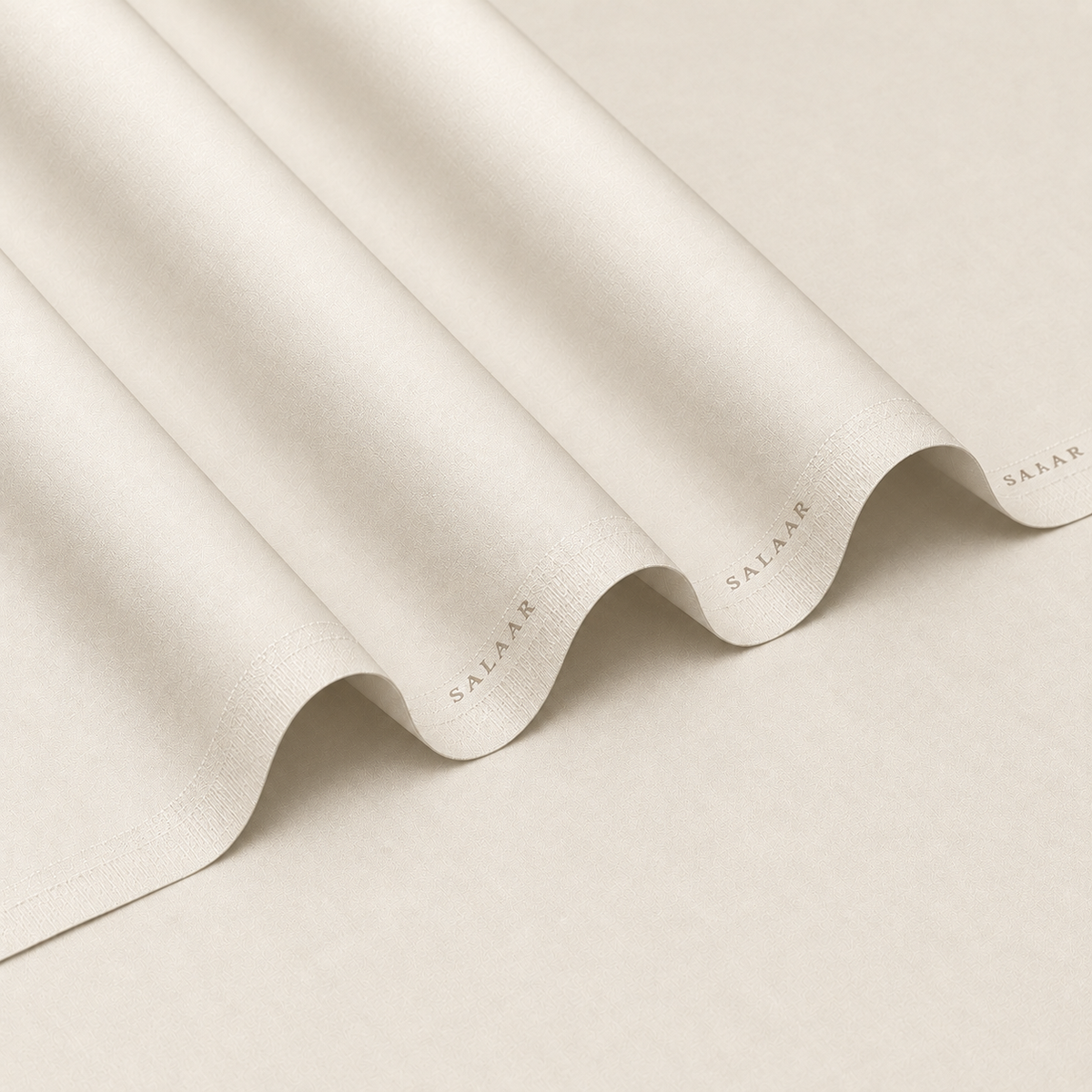 SALAAR Ivory Crown Summer Blend fabric with flowing folds and SALAAR woven border