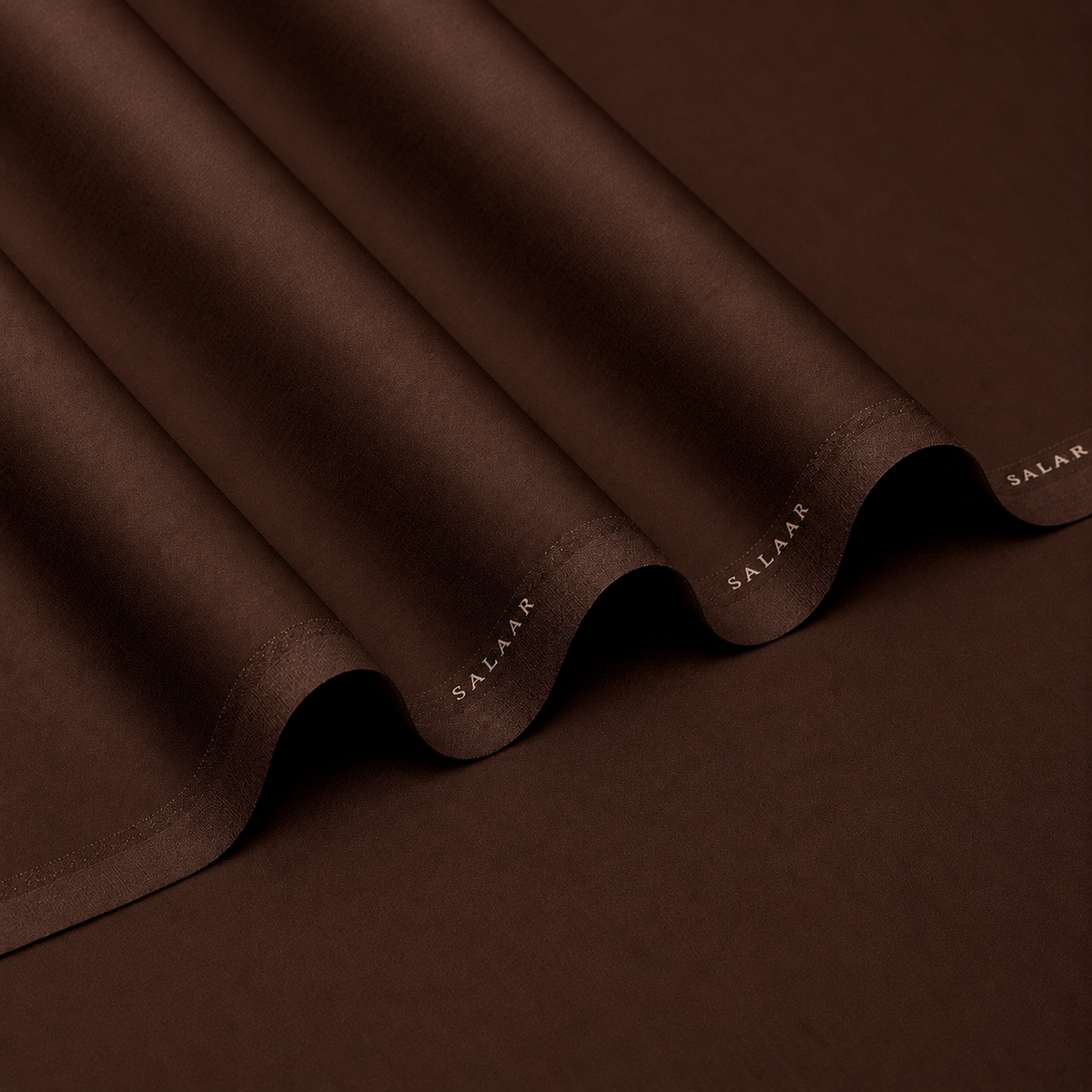 SALAAR Mocha Estate Summer Blend fabric with flowing folds and SALAAR woven border