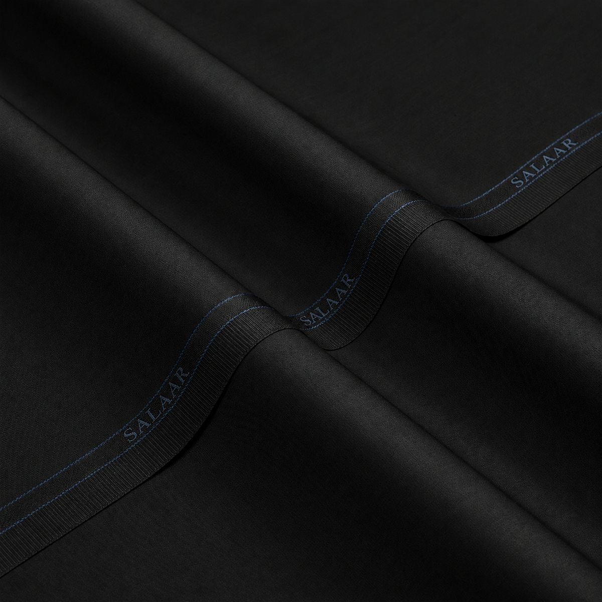 SALAAR Onyx Noir Summer Blend black fabric with woven SALAAR selvedge border