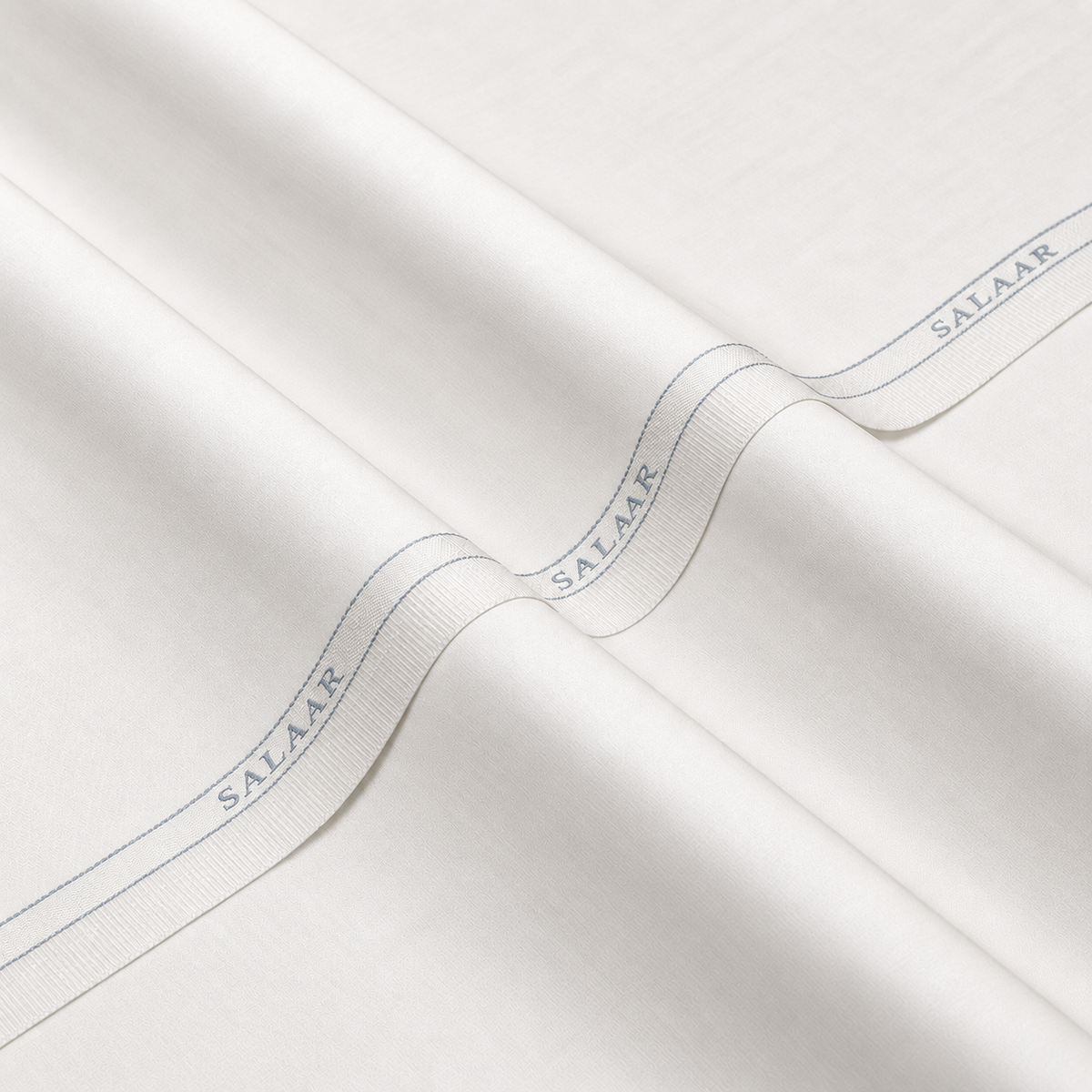 SALAAR Pearl White Boski fabric with woven SALAAR selvedge border